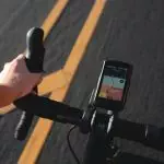 a person riding a bike with a gps app on the handlebars